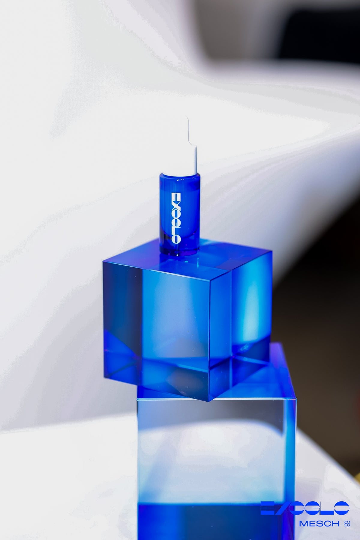EXOGLO Serum 10ml bottle on stacked blue glass cubes