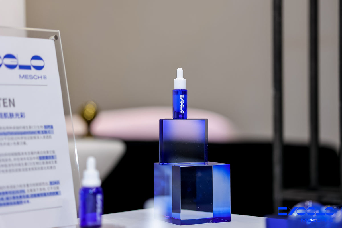 EXOGLO Serum bottles displayed on blue glass blocks